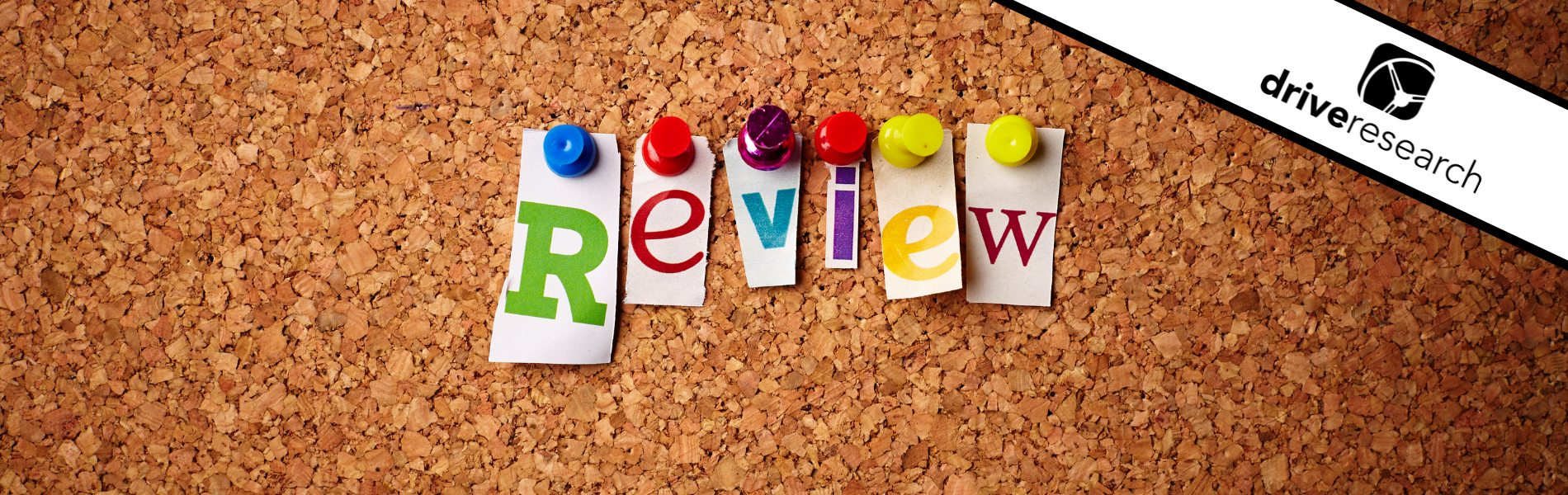 the word review thumb tacked to a cork board - drive research logo