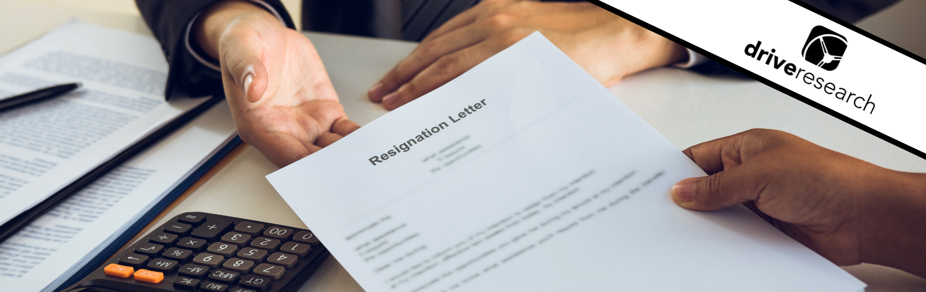 employee handing boss a resignation letter
