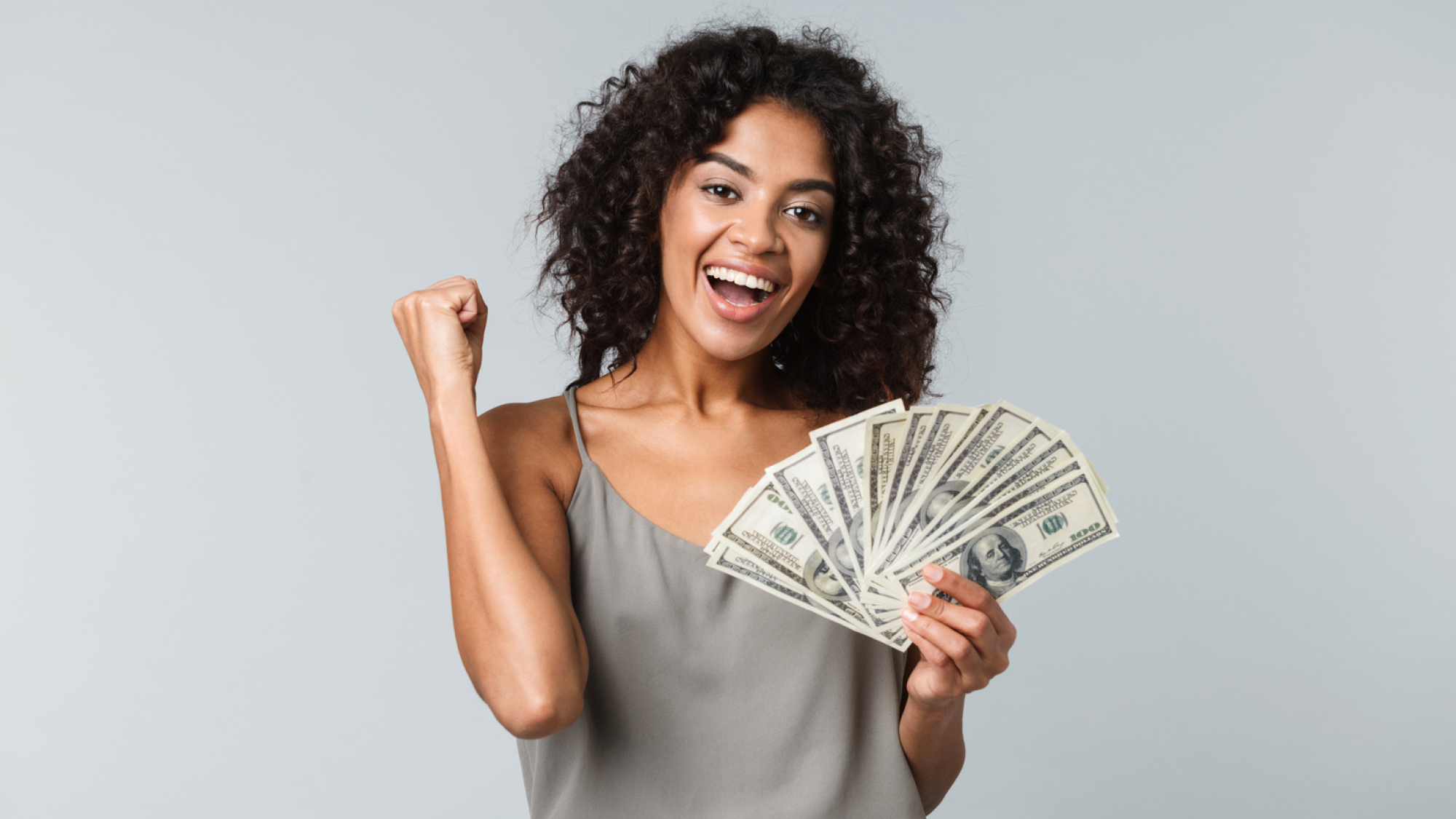 happy young woman holding cash