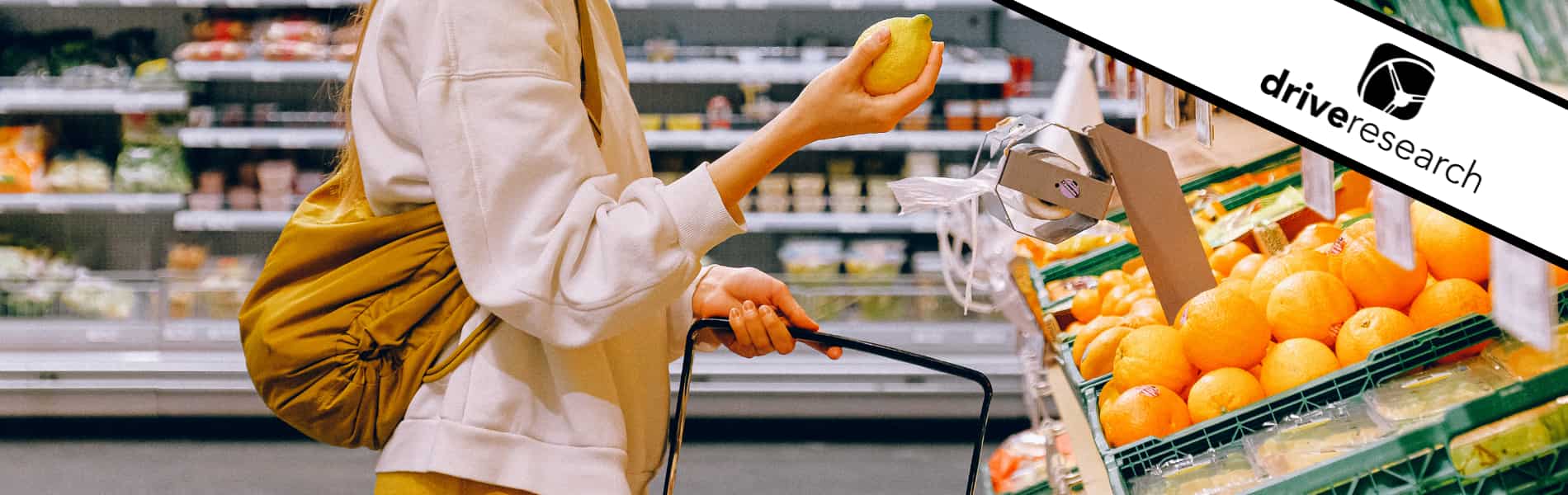 woman at grocery store looking at lemons