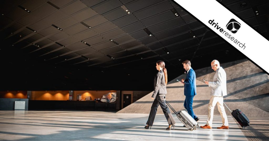 Business people in airport taking survey on tablet - drive research watermark