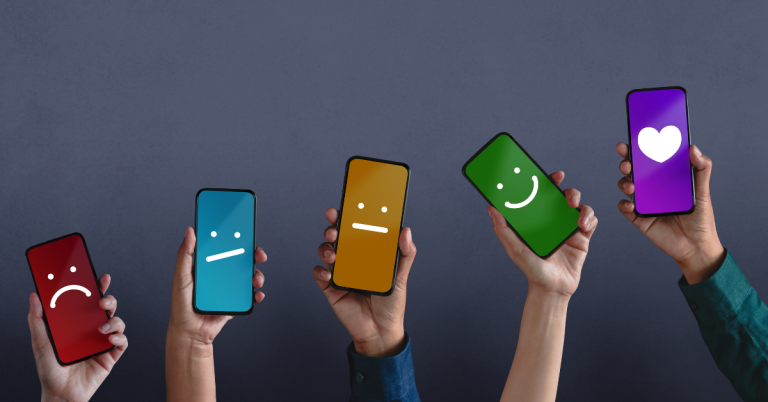 Hands Holding Smartphones with Customer Feedback Smiley Faces