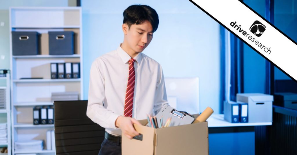 Young asian employee exiting his company with box of his things - drive research watermark