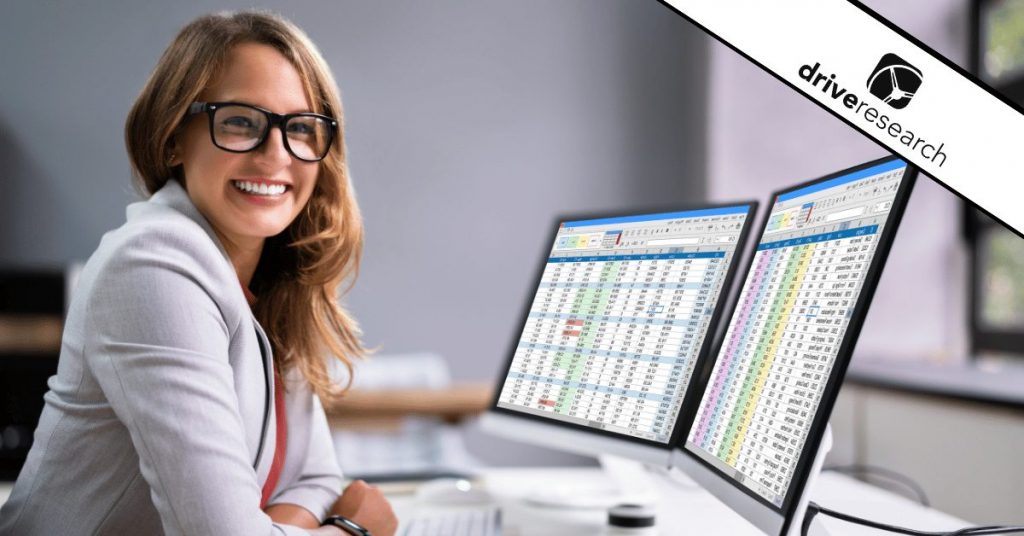 Woman data analyst looking at TURF analysis data on two computer screens - drive research