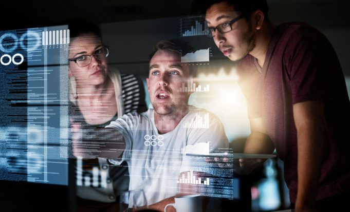 Market research analysts looking at data