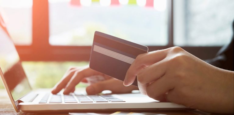Woman Putting Her Credit Card Details on the Laptop