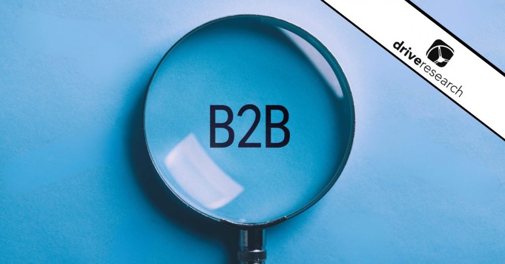 Magnified glass over B2B on blue background - Drive Research