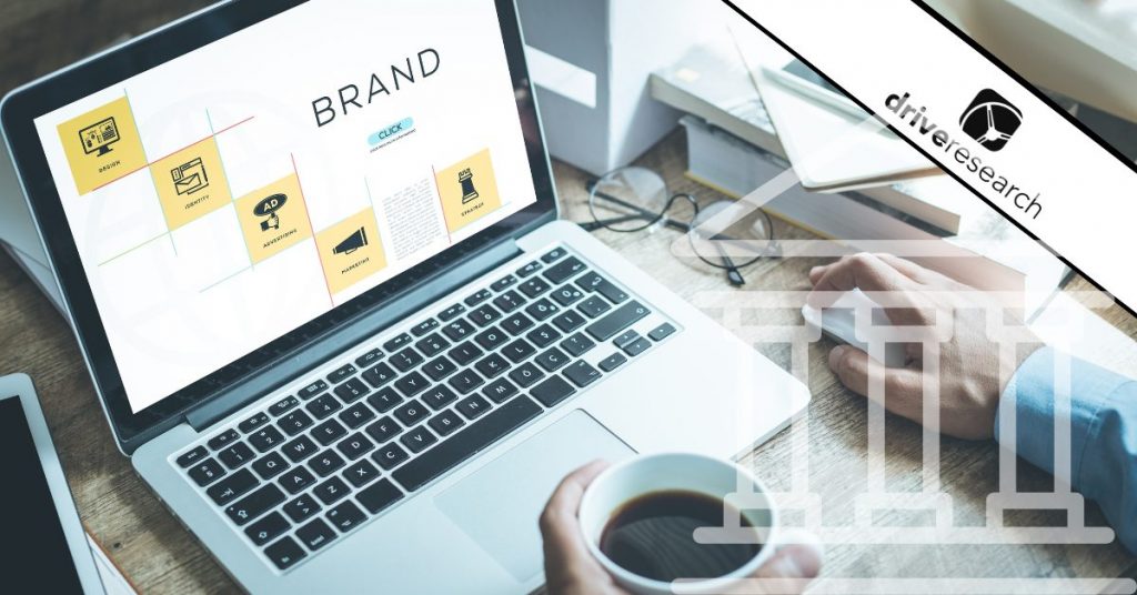 Man working on bank branding research on laptop - drive research watermark