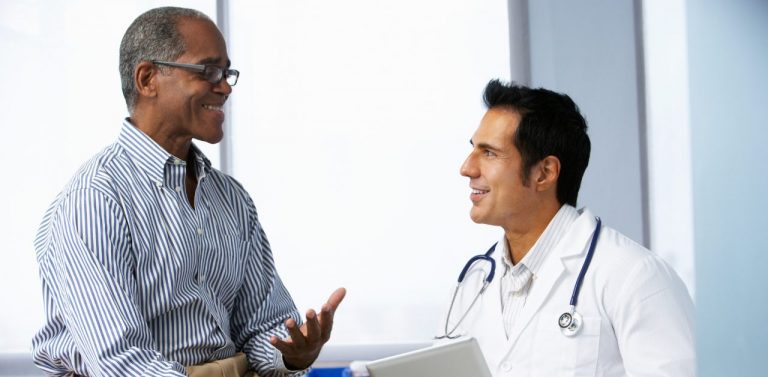 Doctor with male patient in room