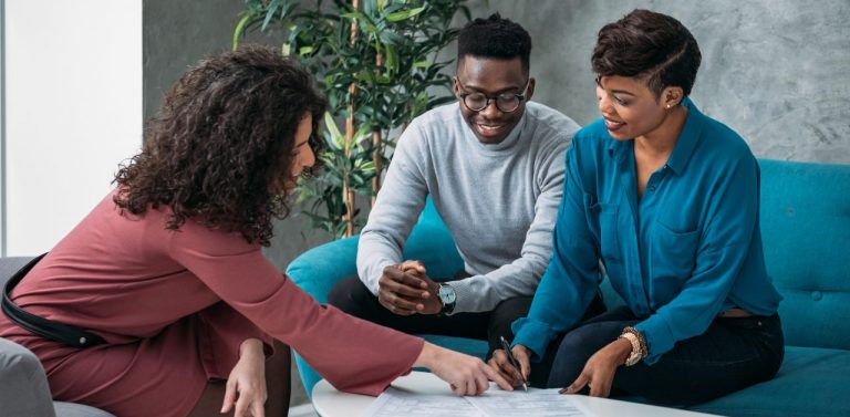 Financial advisor talking to a black couple on couch