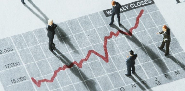 Miniature Business Professionals Analyzing Market Trends - Featured Image