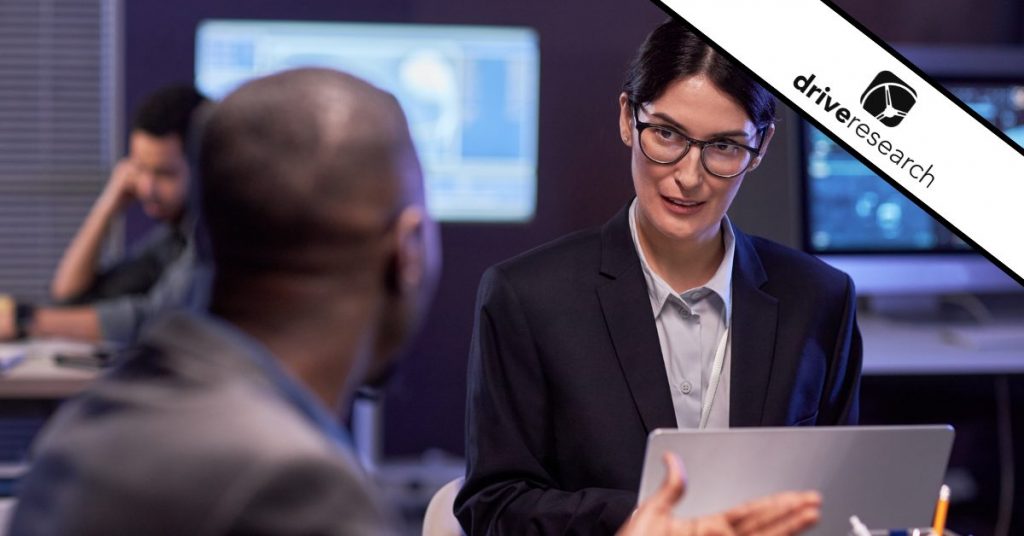 IT decision-makers talking at desks - drive research water mark