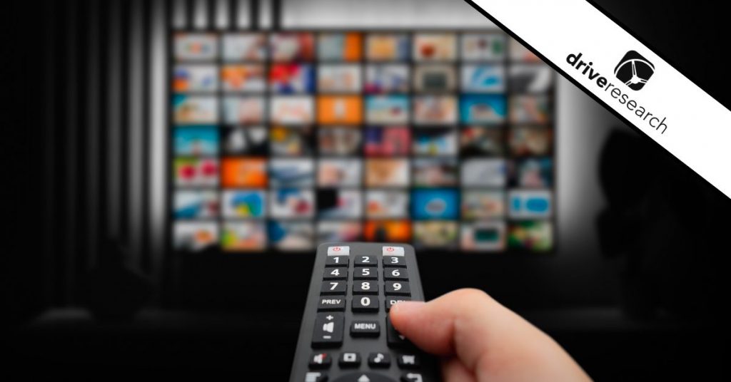 Man Watching TV with Remote Control in Hand
