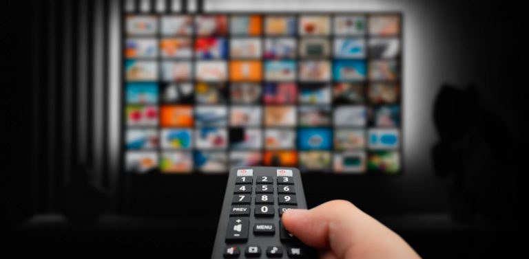 Man Watching streaming apps with Remote in Hand