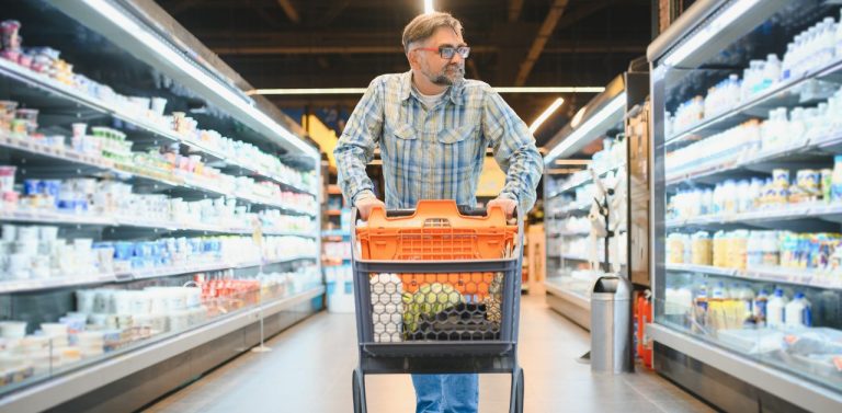 Senior man at grocery store products - featured image