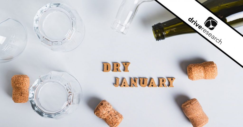 Dry January concept, empty glasses, bottles and corks on a gray background - Drive Research
