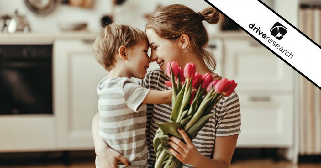 child son gives flowers for mother on mother's day