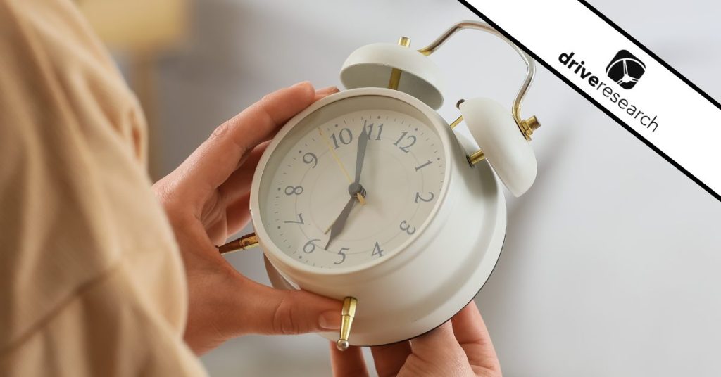 Woman Changing Clock for Daylight Saving Time in Bedroom, Closeup - drive research