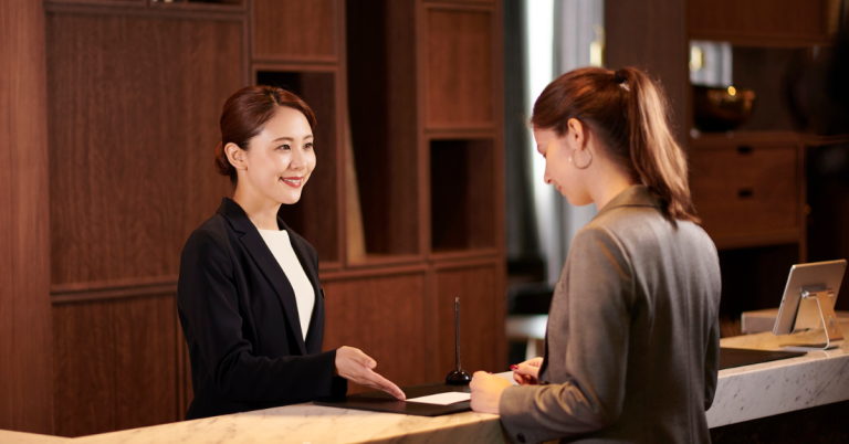 Hotel employee providing satisfactory service to a guest